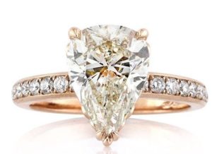 pear shaped diamond solitaire ring with diamonds on band